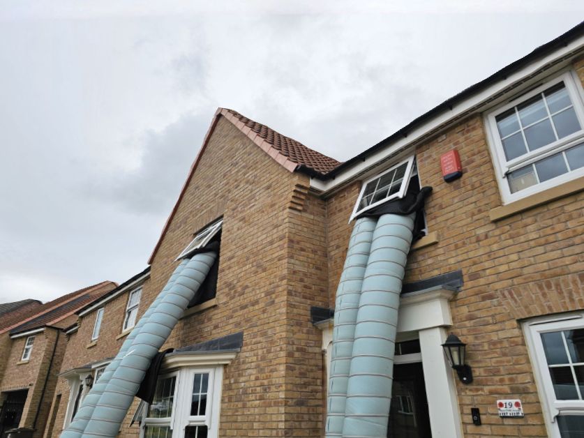 Multiple heat treatment ducts connected to a modern semi-detached house for whole-property bed bug elimination